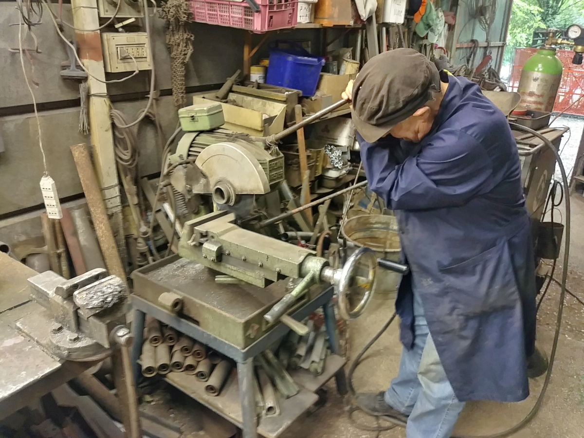 The main workshed is tiny and jam packed with tools. Here Bruno was using a cold cut saw to cut off small steel brackets that he later welded in place.